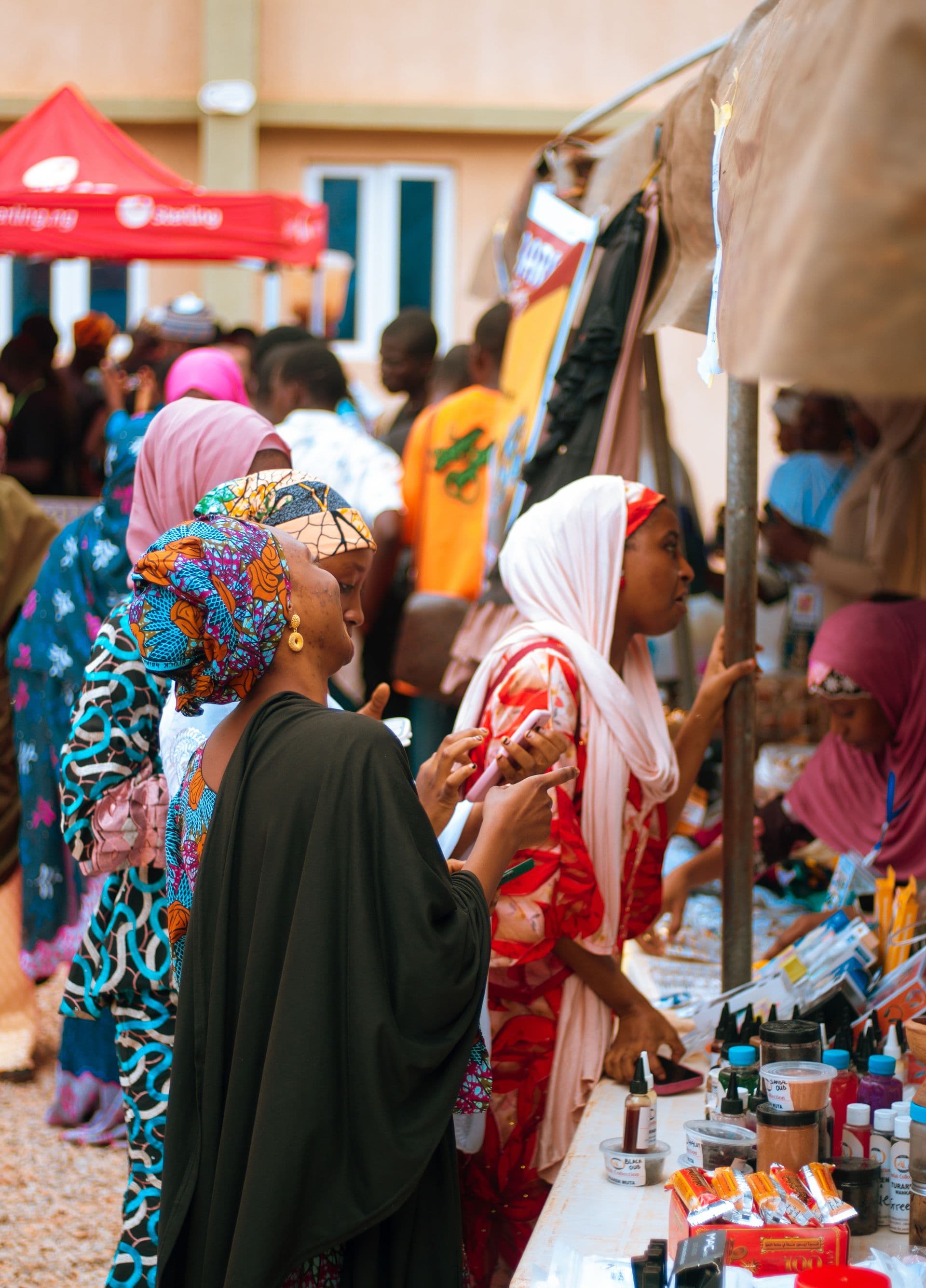 Happy African merchant showcasing products